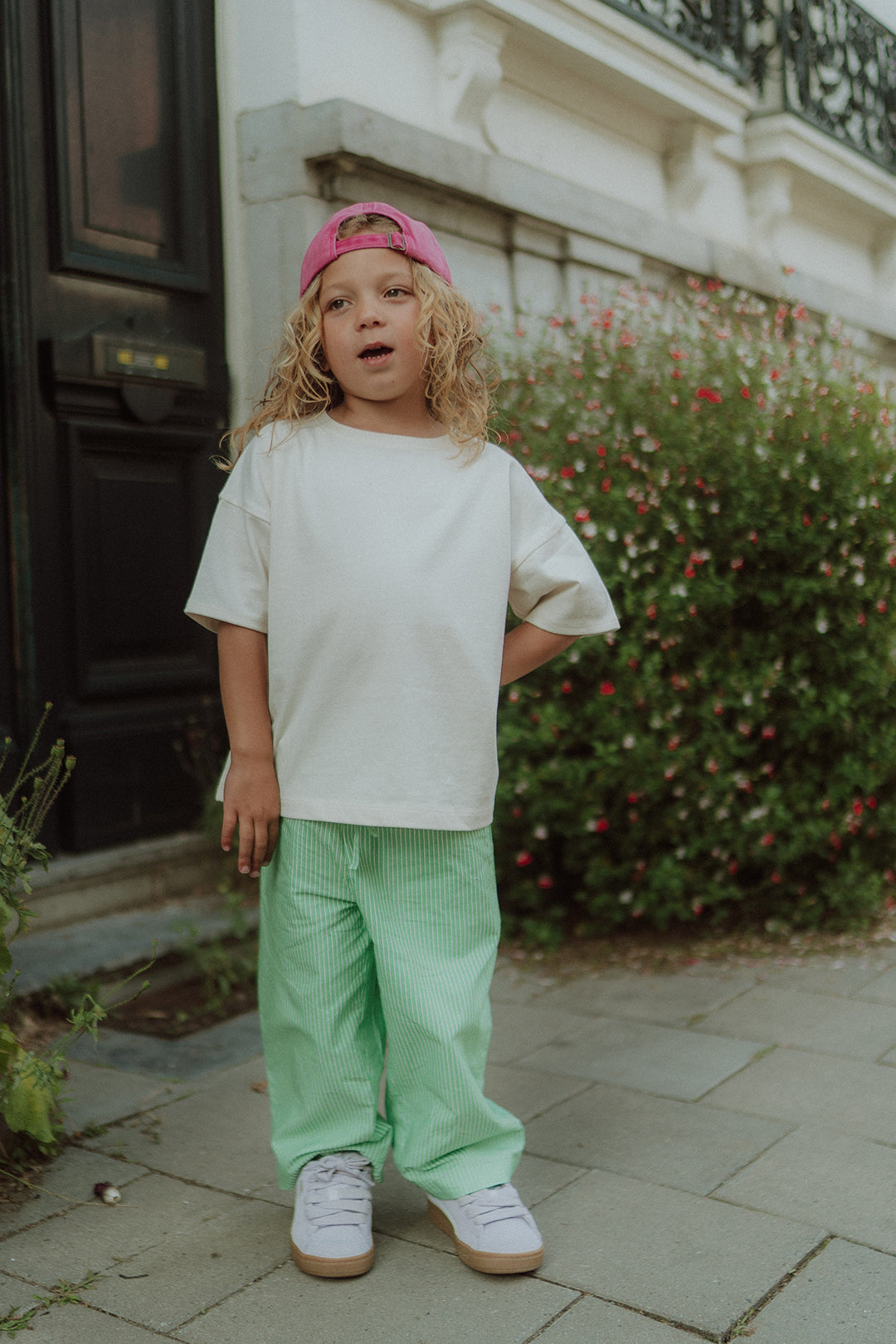 Little boy wearing the Drew striped pants by Wolvie in the color green
