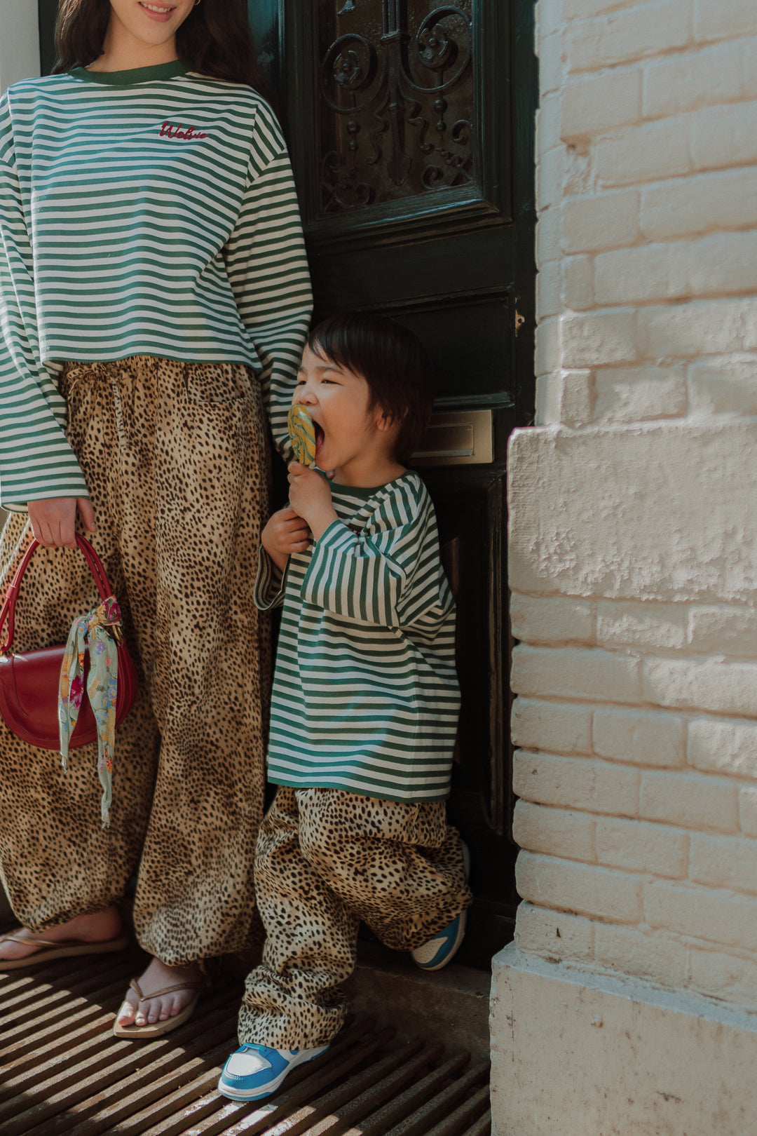 Matching mom and child outfit green striped shirt and leopard pants street style