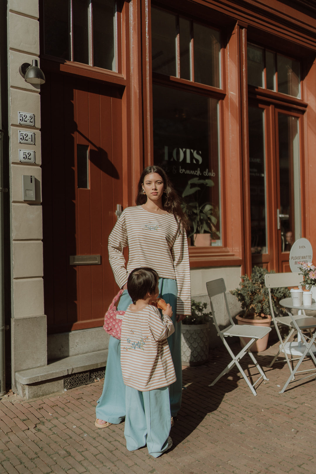 Matching mom and son outfit with striped shirts and light blue wide leg pants