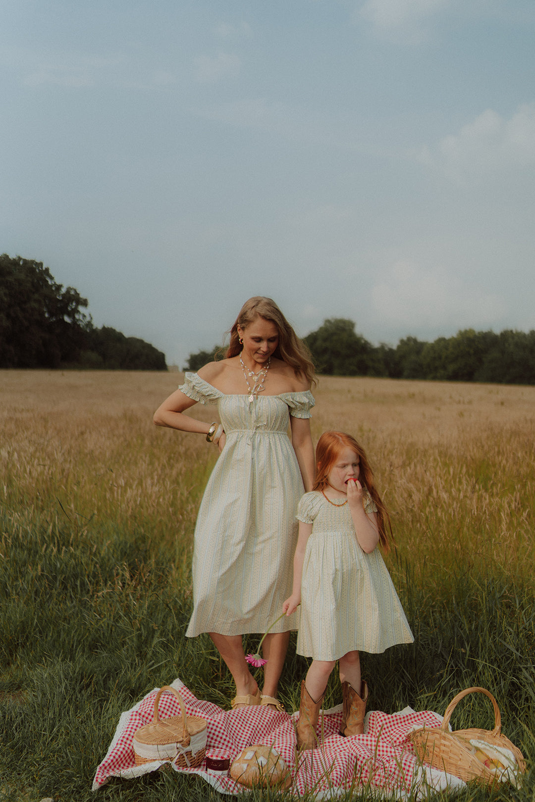Mother and daughter wearing matching light summer dresses