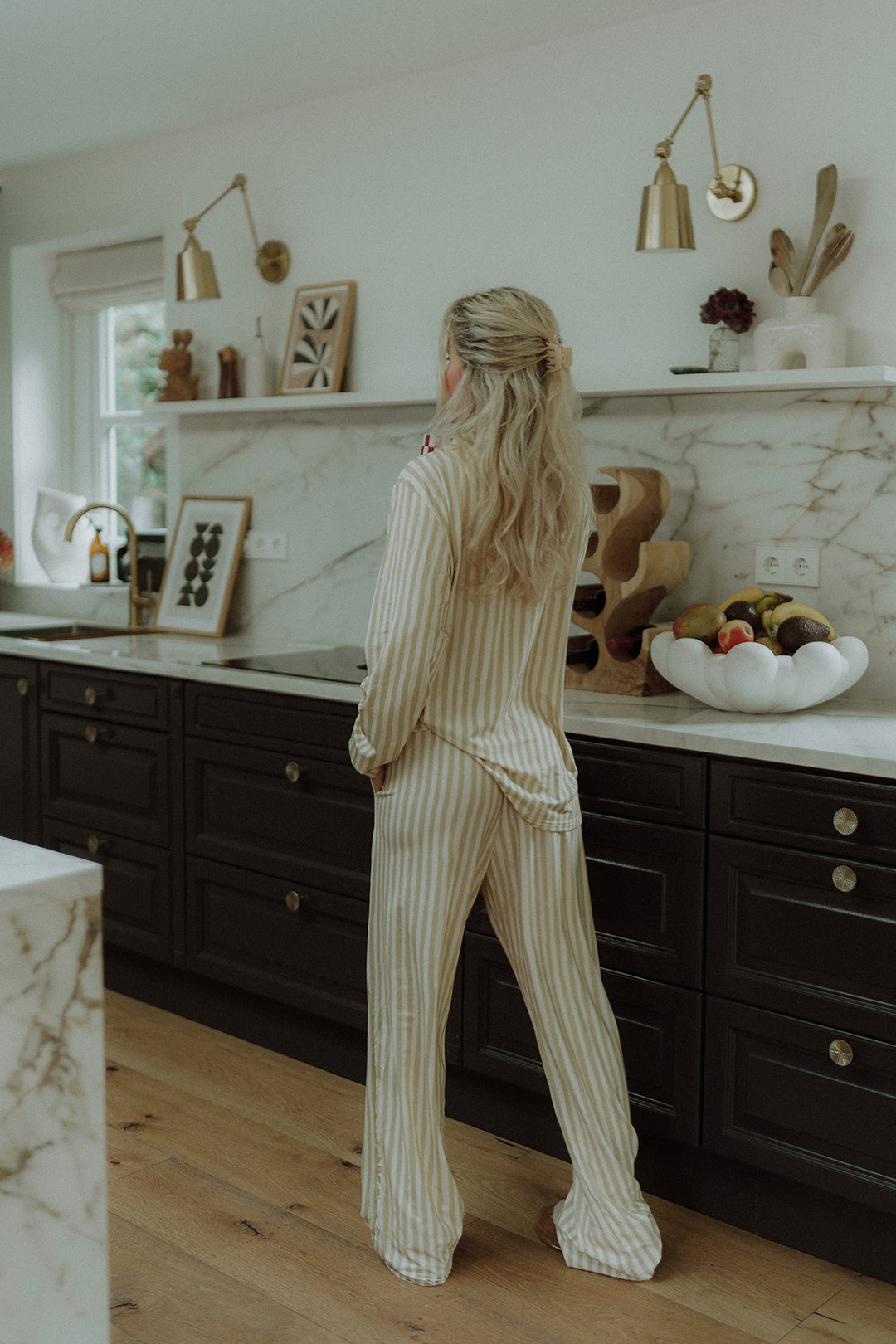 Woman wearing a matching striped pyama set by Wolvie