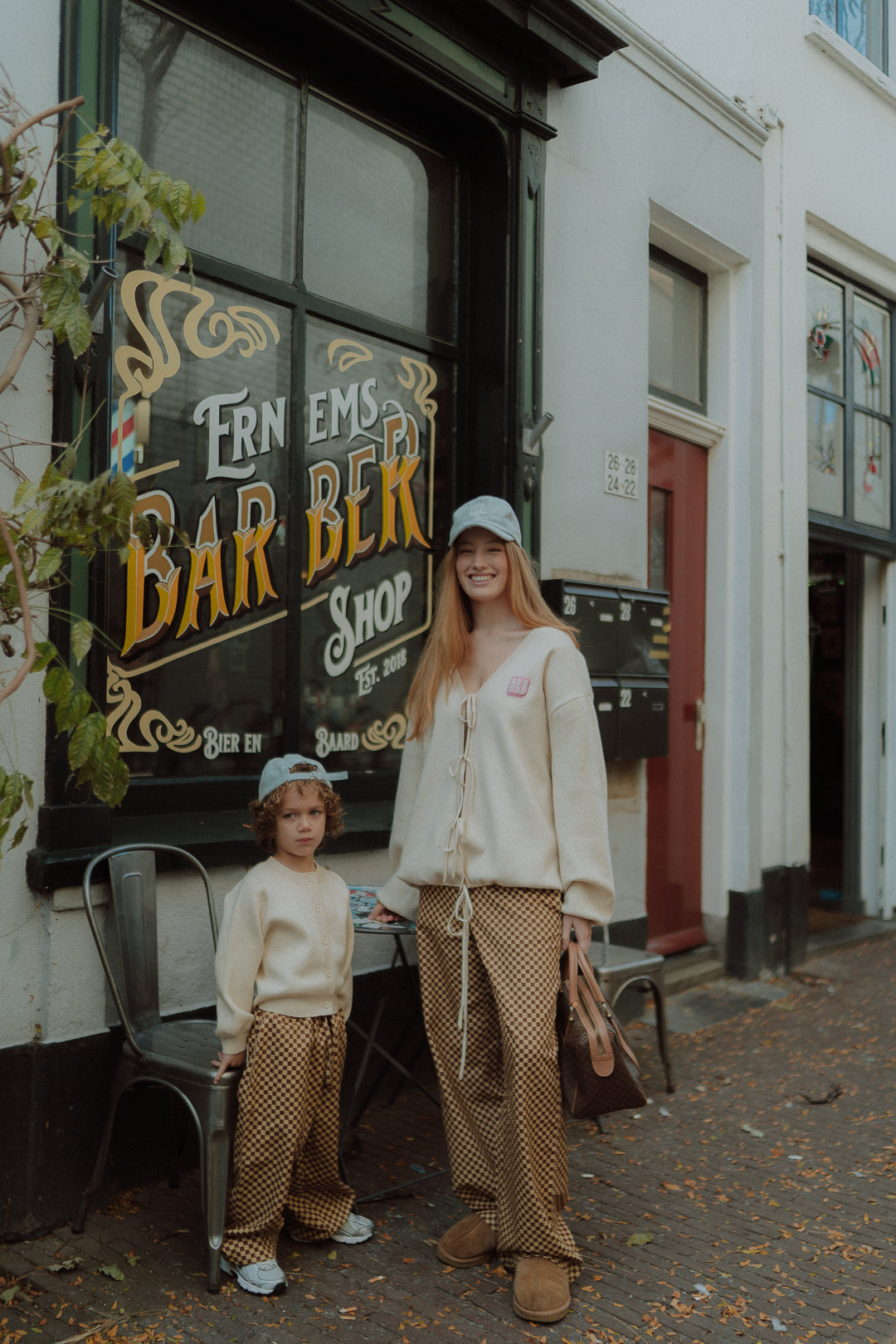 Mother and child wearing matching neutral Wolvie outfits in the city