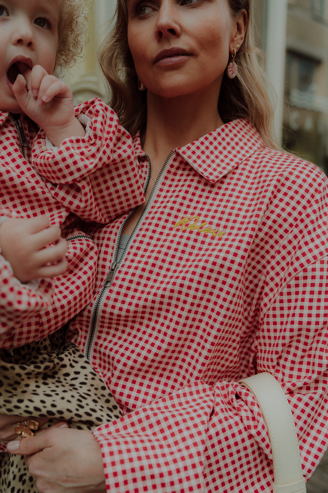 Mom and child in matching red checkered outfit stylish close up