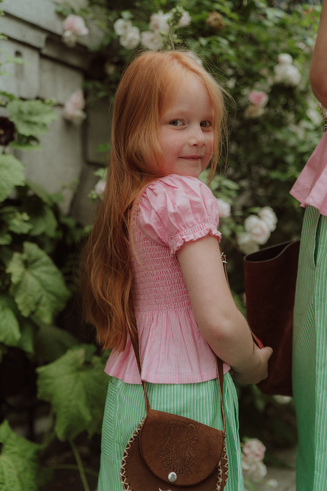 Little girl wearing pink and green set
