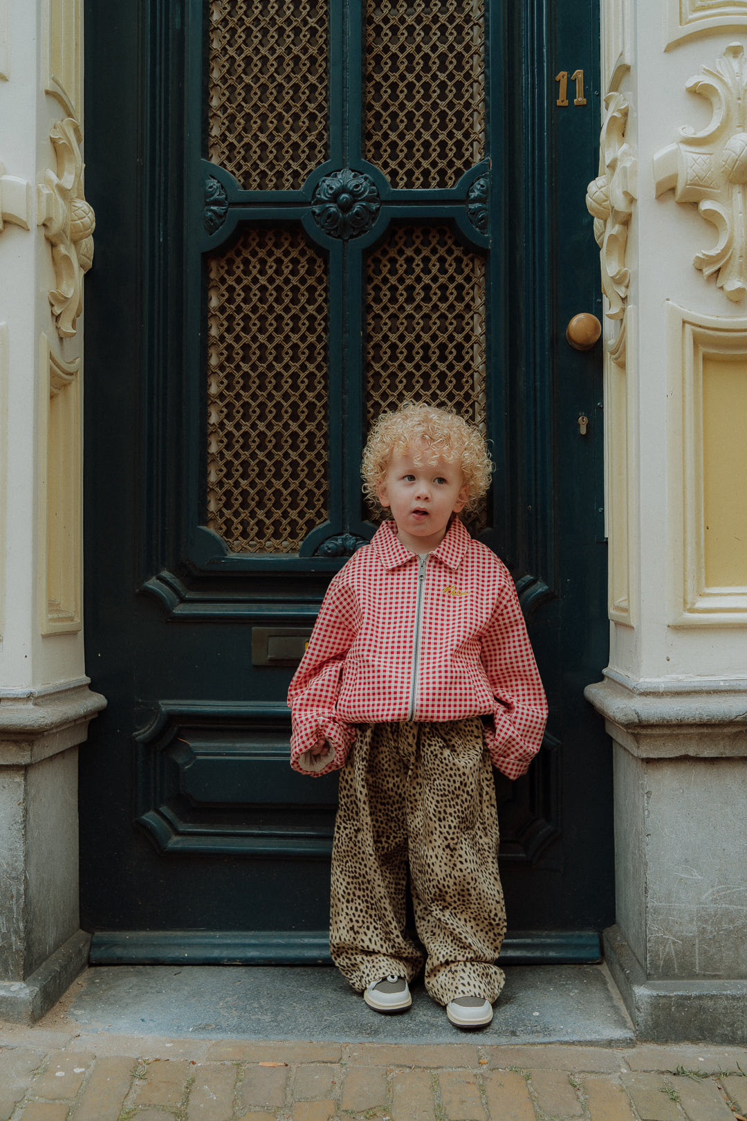 Matching mom and toddler outfit with red gingham jacket and leopard pants