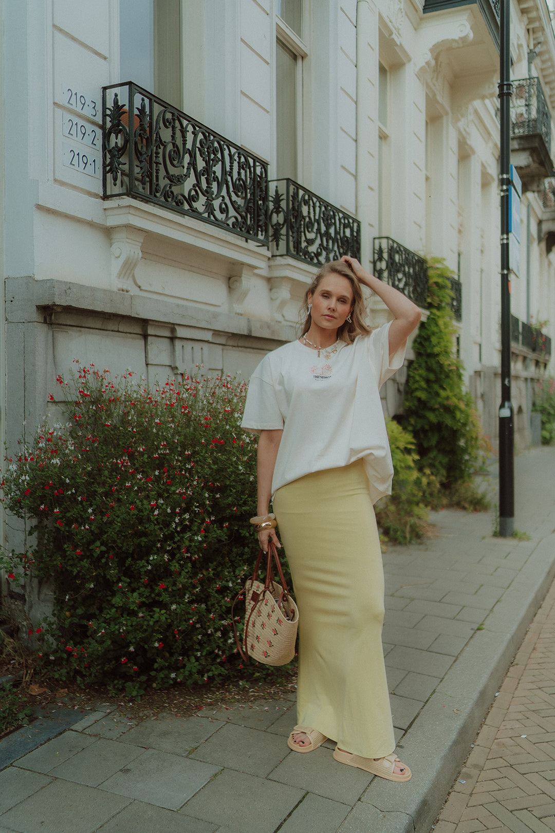 Woman wearing oversized shirt and yellow skirt by Wolvie