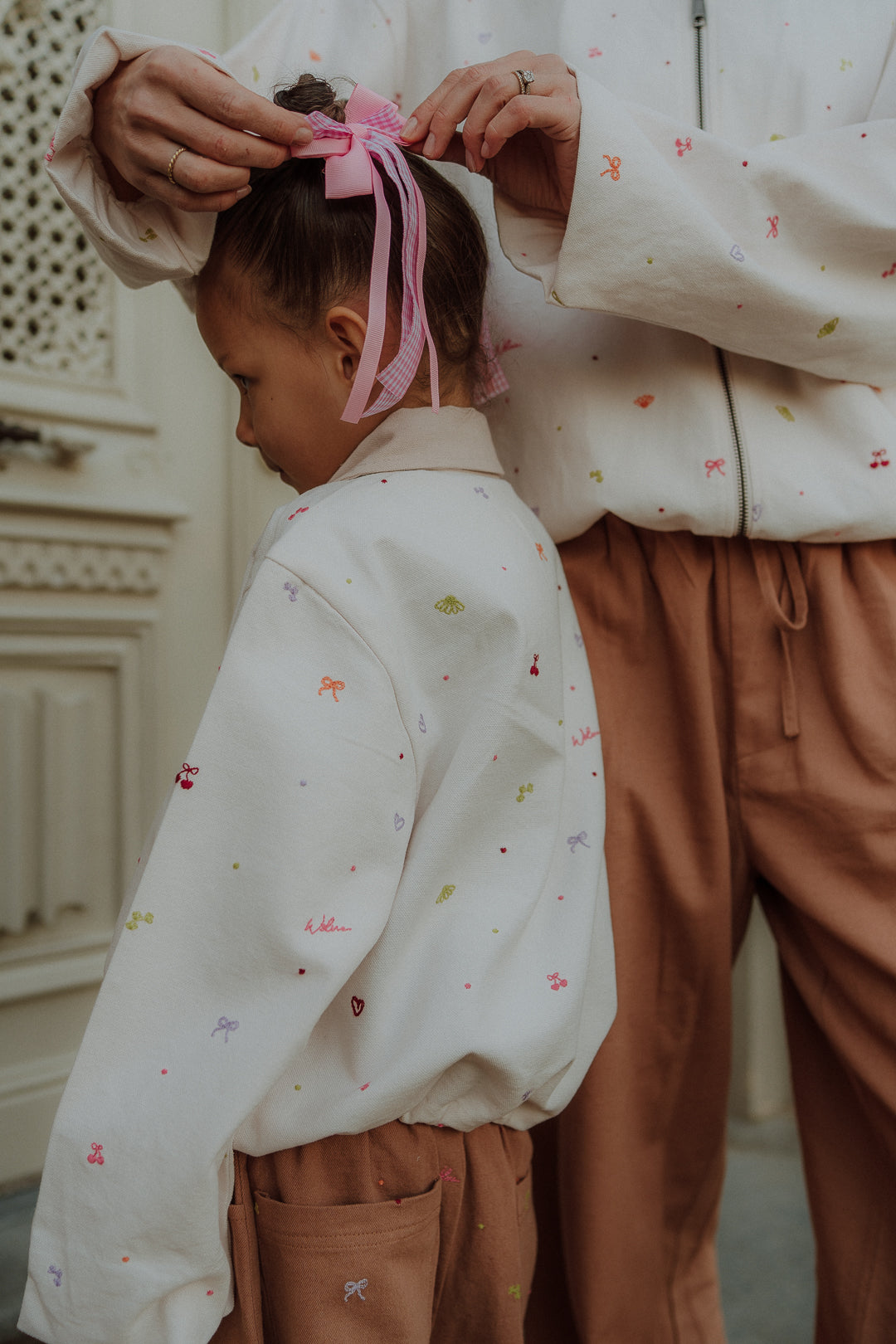 Matching kids and mom camel embroidery pants with detailed embroidery from Wolvie SS26 collection