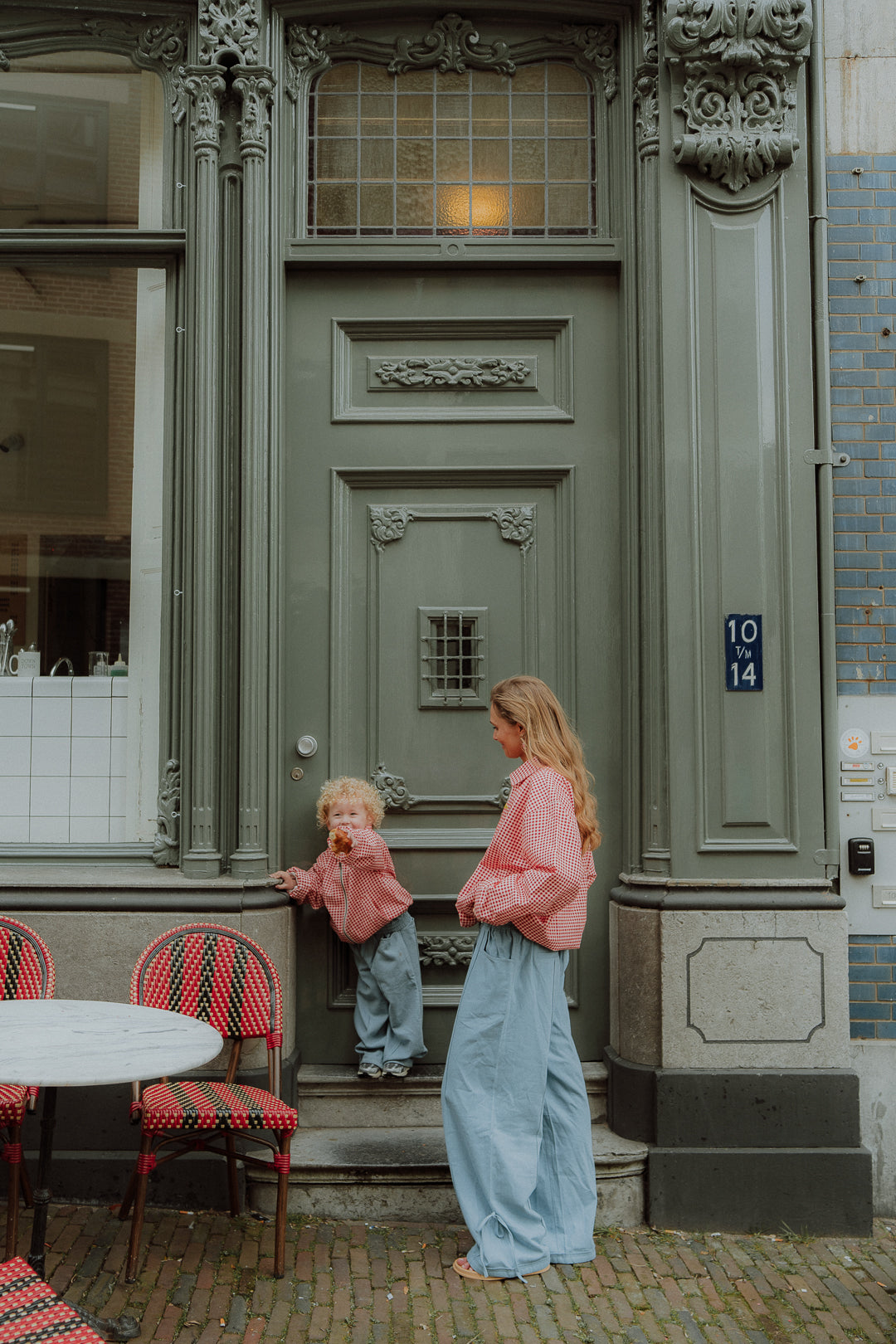 Matching mom and toddler outfit with red gingham jackets and blue pants