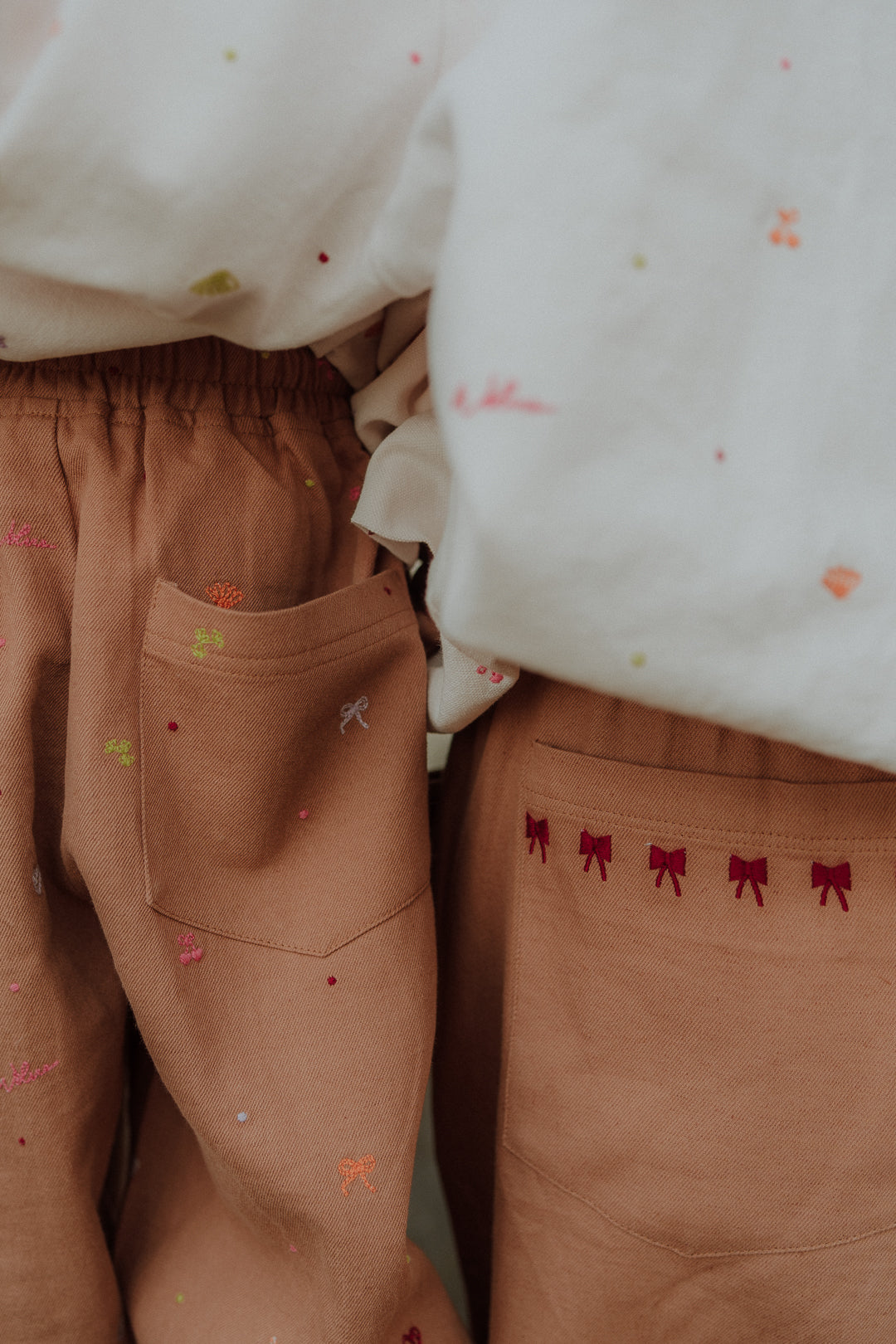 Matching kids and mom camel embroidery pants with detailed embroidery from Wolvie SS26 collection.