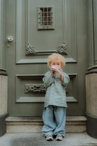 Kids  fashion outfit with green striped oversized tee and loose blue pants