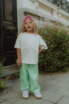 Little boy wearing the Drew striped pants by Wolvie in the color green