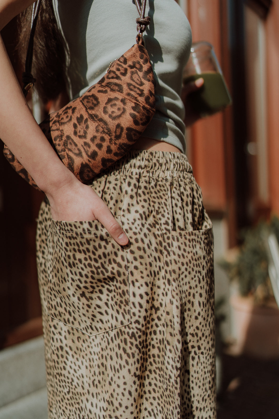 Leopard print skirt outfit detail with matching bag street style fashion