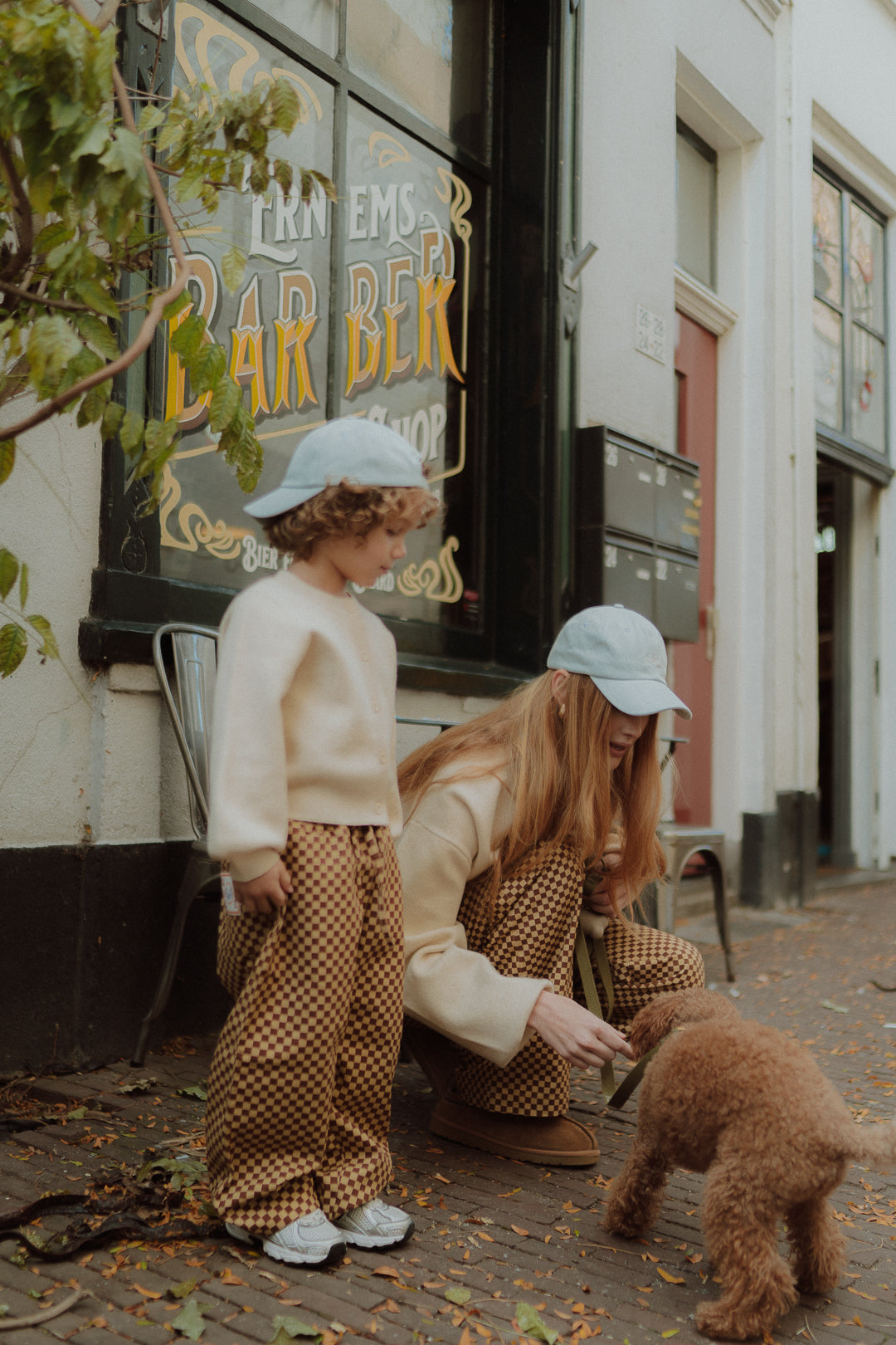 Mom and child wearing matching checker pants and beige knitwear