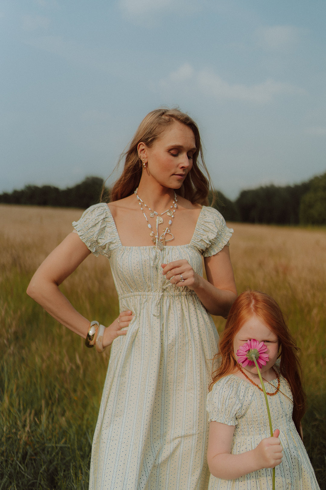 Mom and daughter wearing matching summer dresses by Wolvie