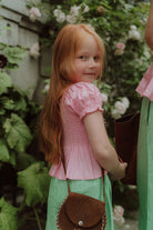 Little girl wearing pink and green set