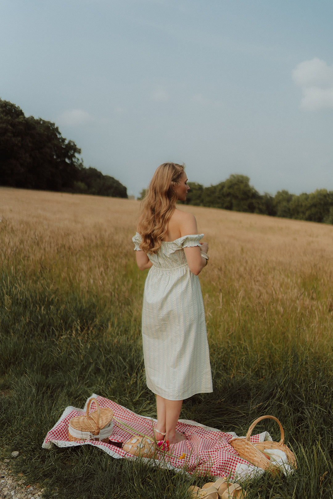 Woman wearing a light off-shoulder summer dress 