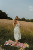 Woman wearing a light off-shoulder summer dress 