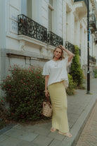 Woman wearing oversized shirt and yellow skirt by Wolvie