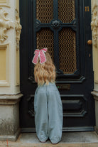 Kids outfit with blue wide pants and red gingham bow from Wolvie