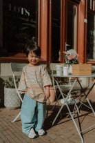 Comfortable kids outfit by WOLVIE featuring a soft striped shirt and relaxed blue pants for everyday wear