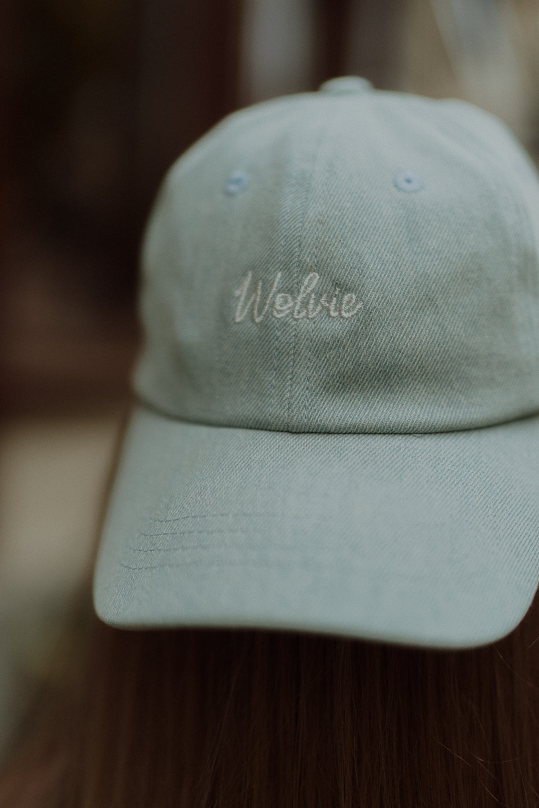 Close-up of a light blue Wolvie cap with embroidered logo.