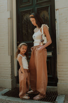 Matching mom and daughter outfit by WOLVIE featuring white tops and relaxed brown pants in a soft neutral style.