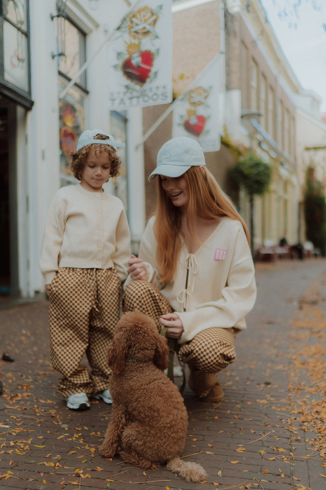 Matching mommy and me outfit with checkered pants and neutral cardigan by Wolvie Women & Kids.  