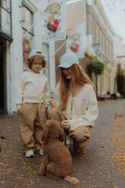 Matching mommy and me outfit with checkered pants and neutral cardigan by Wolvie Women & Kids.  