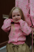 Young girl wearing a pink floral cardigan