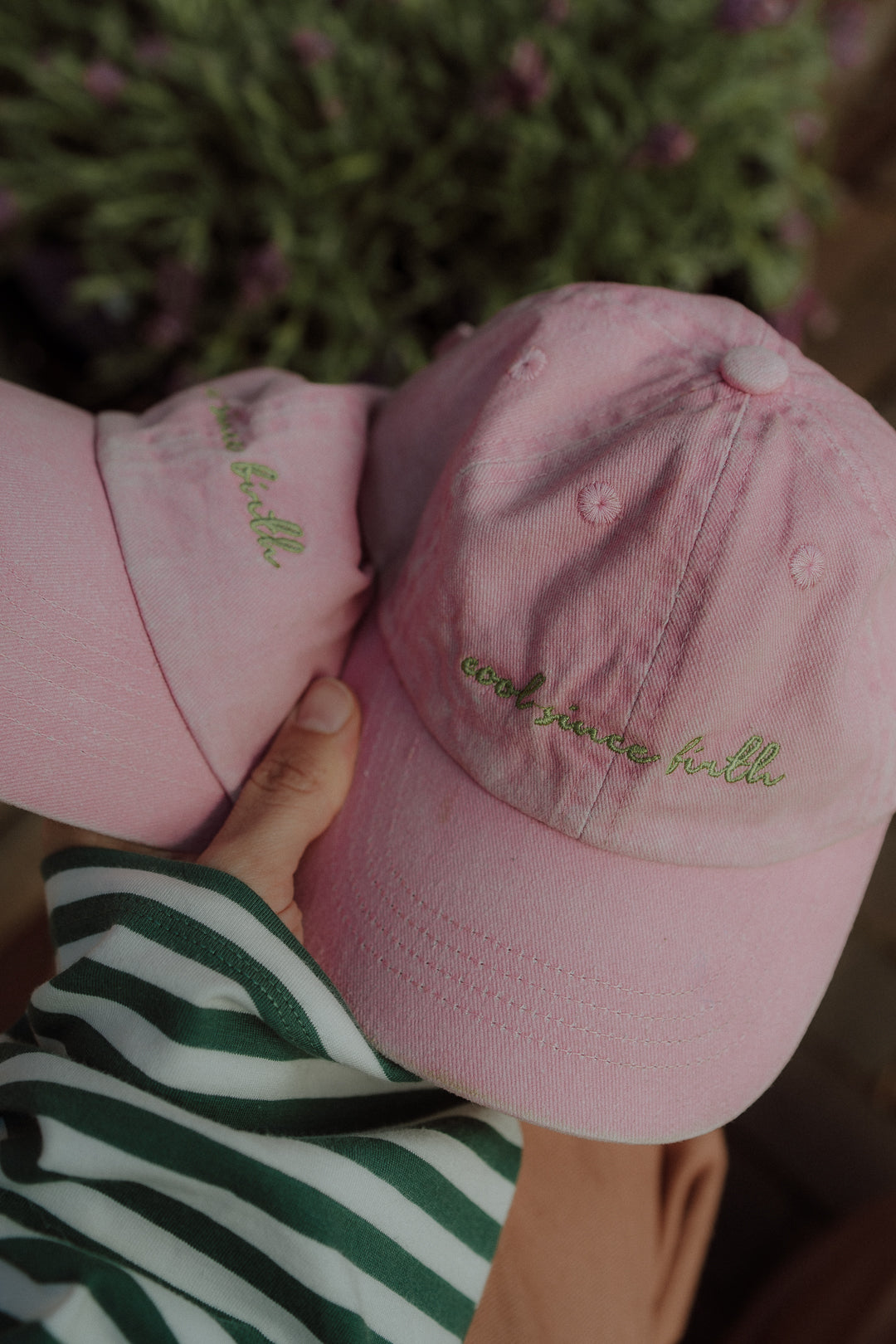Pink embroidered WOLVIE cap featuring the ‘cool since birth’ quote  a playful matching accessory for kids and moms.
