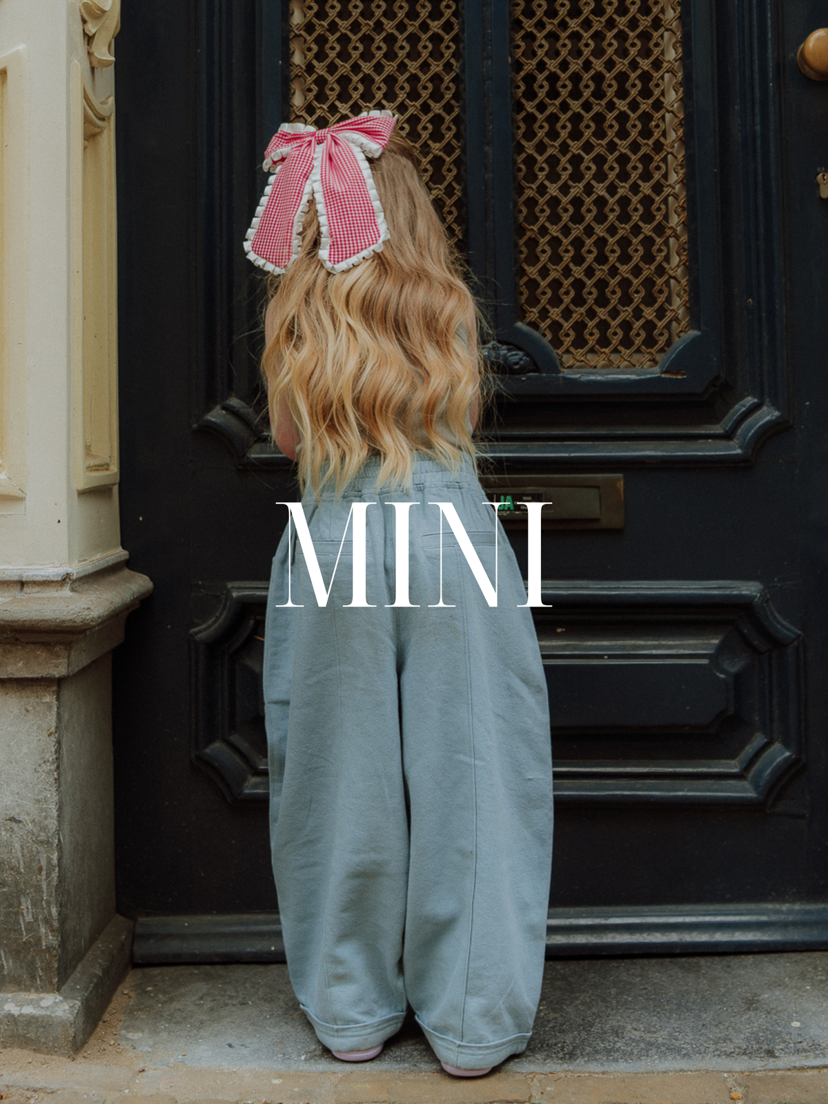 Kids outfit with blue oversized pants from Wolvie SS26 collection styled in a street setting.