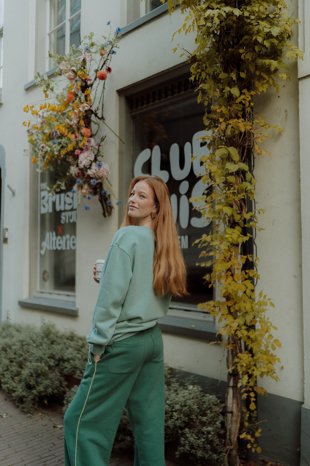 Woman wearing oversized green Wolvie set 