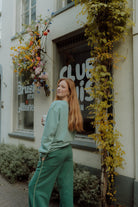 Woman wearing oversized green Wolvie set 